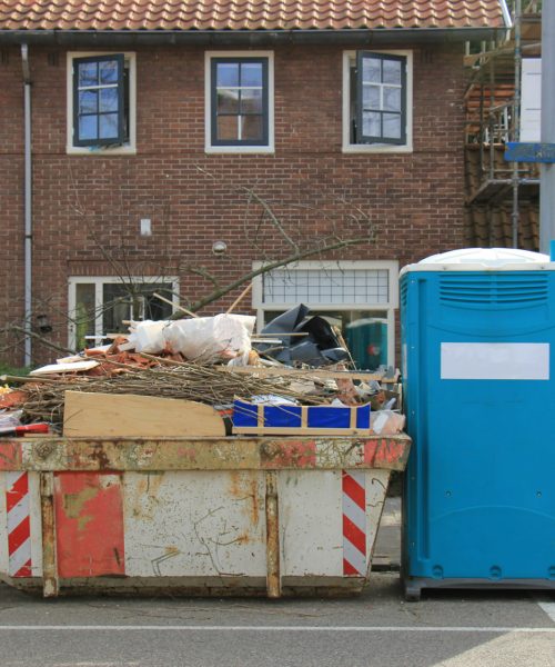 Loaded dumpster near a construction site, a home renovation or maintenance